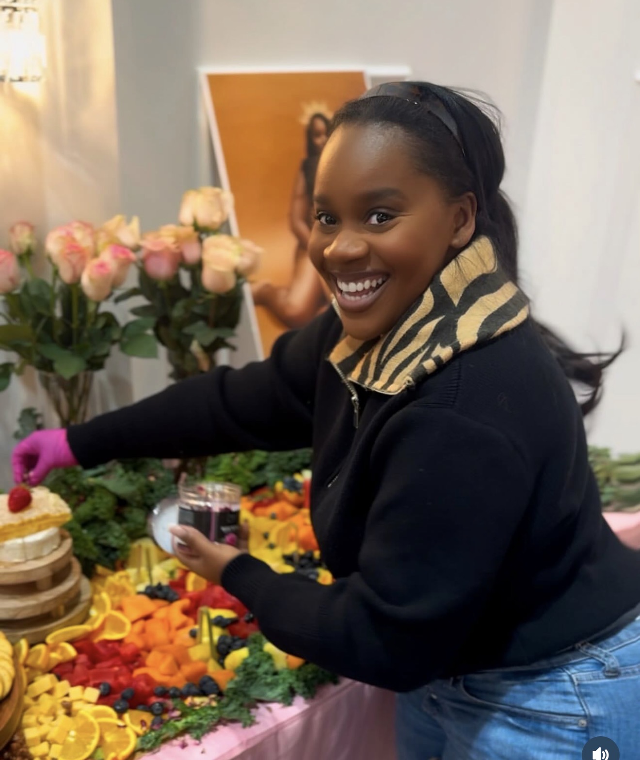 Brionna, founder of Brie'vine Taste, arranging a vibrant grazing table